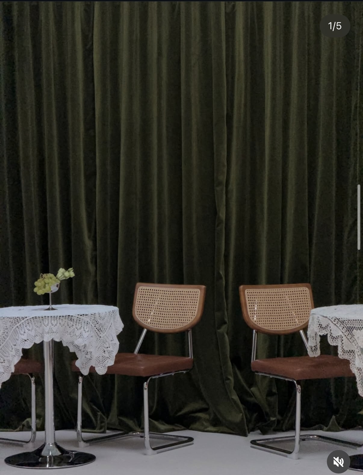 Olive velvet curtain seating set with chrome tables and cane chairs.